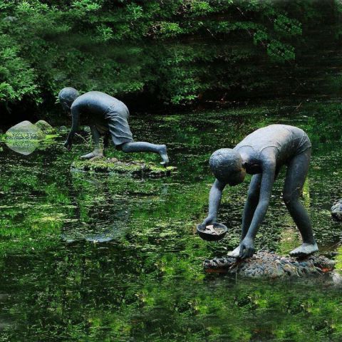 在水里干活的儿童铜雕